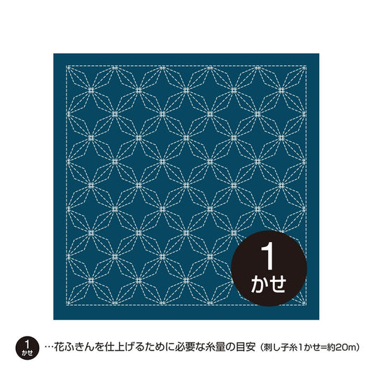 A square with a repeating pattern of blue and white geometric shapes, resembling a quilt or textile design.