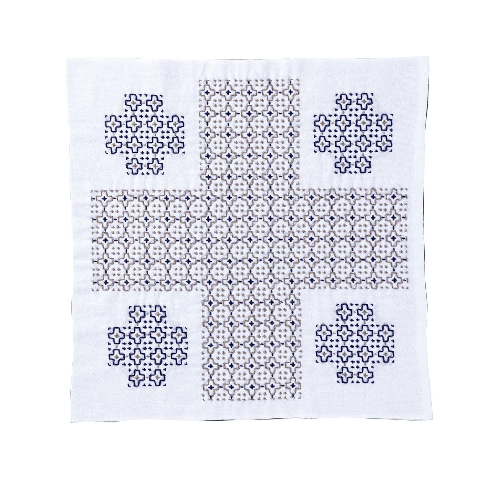 a square piece of fabric with a repeating pattern of small blue and white shapes, creating a visually striking design.