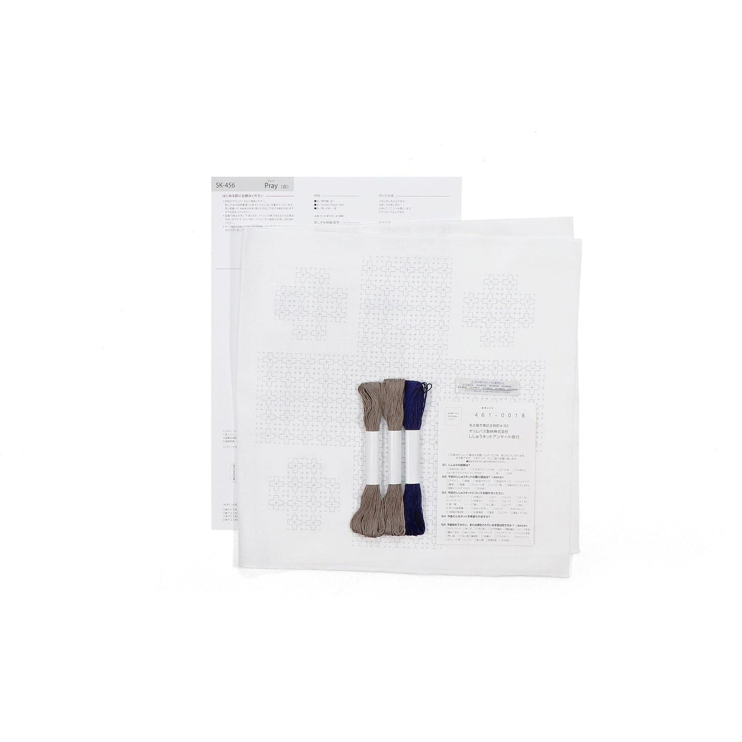 a set of instructions or a pattern for a sewing or crafting project, along with some thread and a piece of paper.