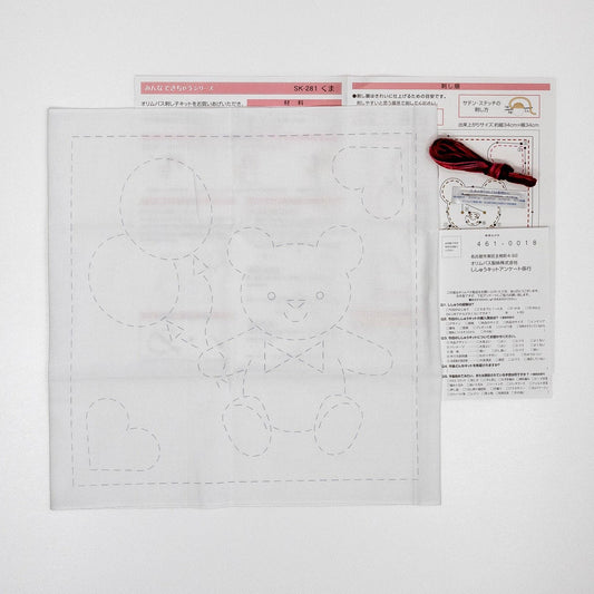 a sewing kit with instructions and a pattern for a teddy bear. The kit includes a diagram of the teddy bear and instructions for sewing the bear.