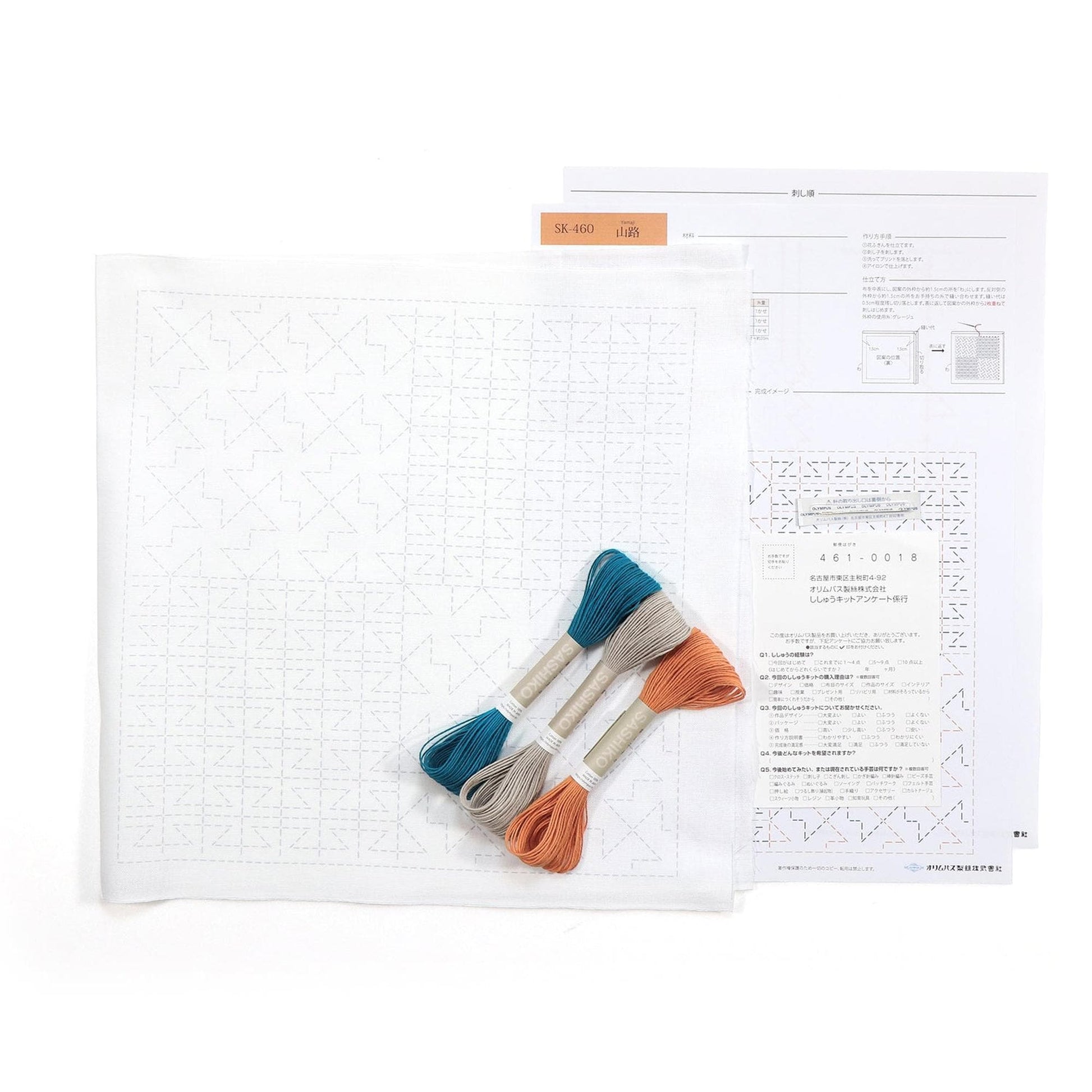 a sewing kit with a white paper, a set of embroidery floss, and some instructions or diagrams.