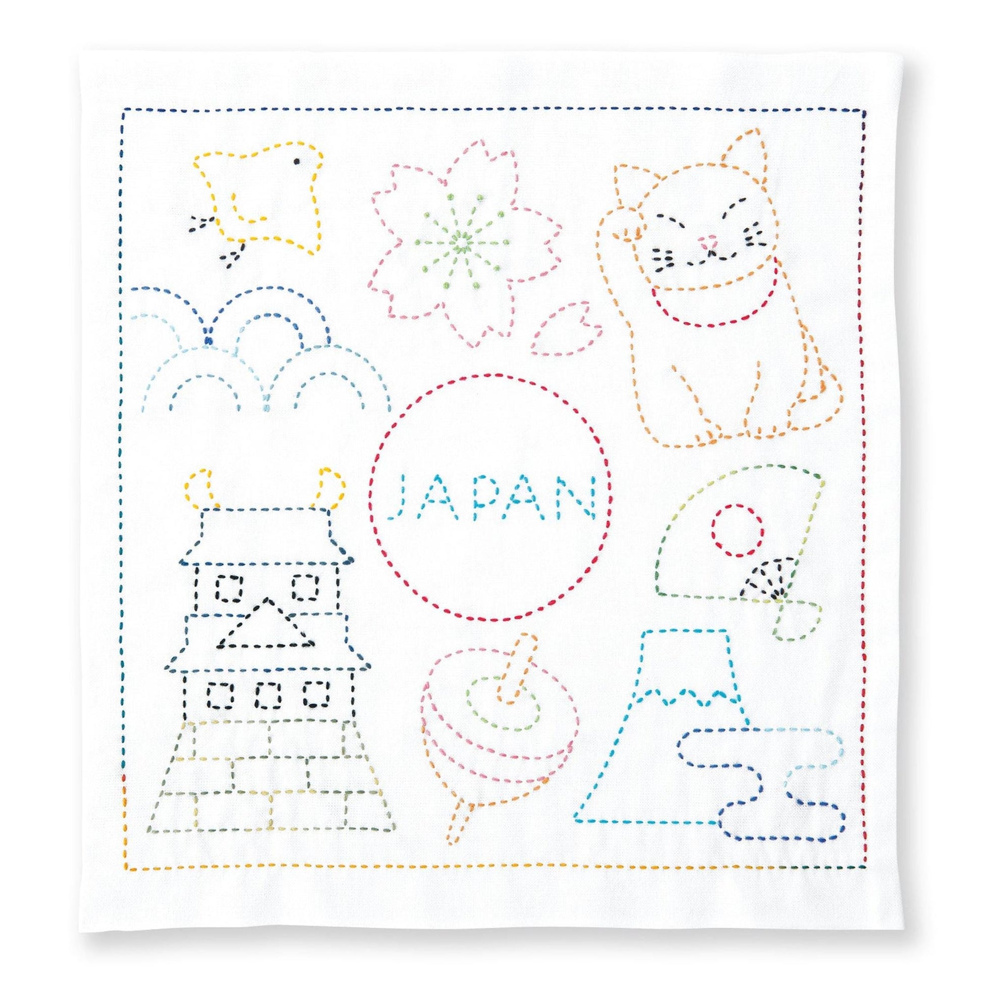 The image is a colorful embroidery or needlepoint design featuring various Japanese-themed elements, including a cat, a bird, a flower, and a temple. The word "JAPAN" is prominently displayed in the center of the design.