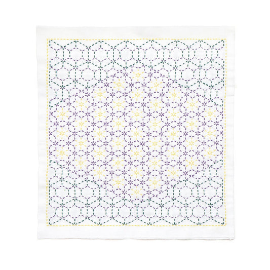 a square-shaped fabric with a repeating pattern of purple and yellow hexagons, creating a visually striking and intricate design.
