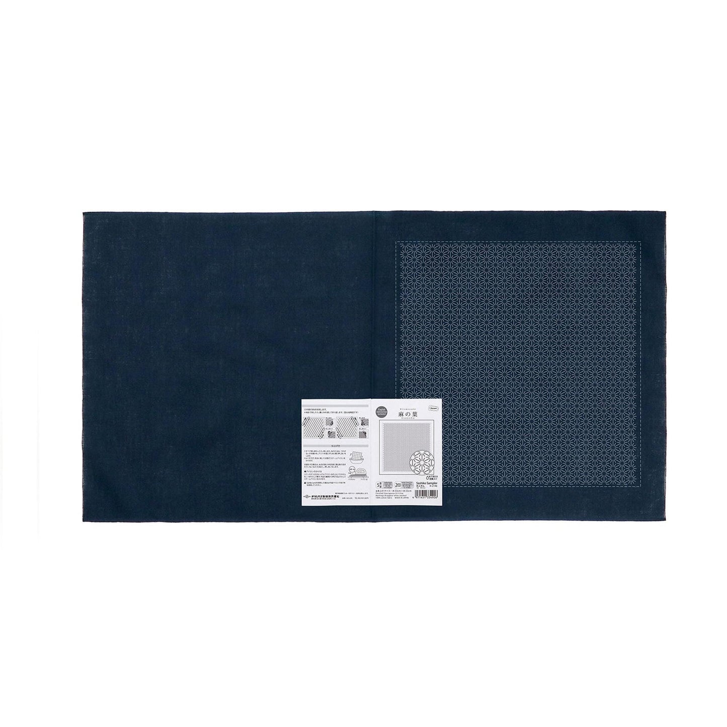 a dark blue fabric with a white label attached to it, which appears to be a product label or instructions.