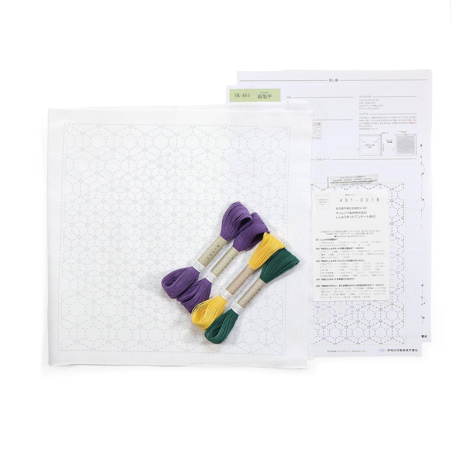 a sewing kit with a white square pattern, purple and green thread, and instructions for a sewing project.