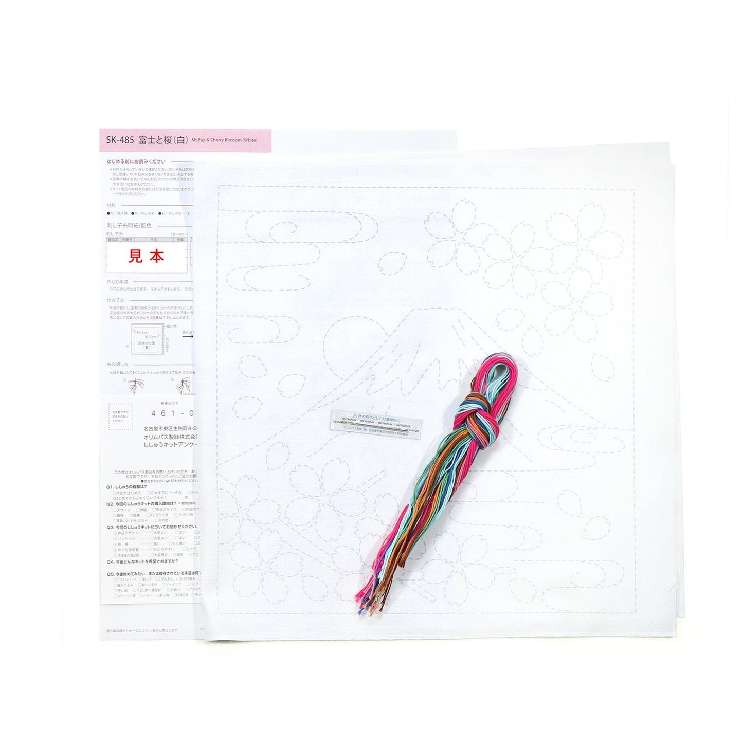a craft kit with instructions and materials, including a piece of paper with a drawing and a spool of thread.