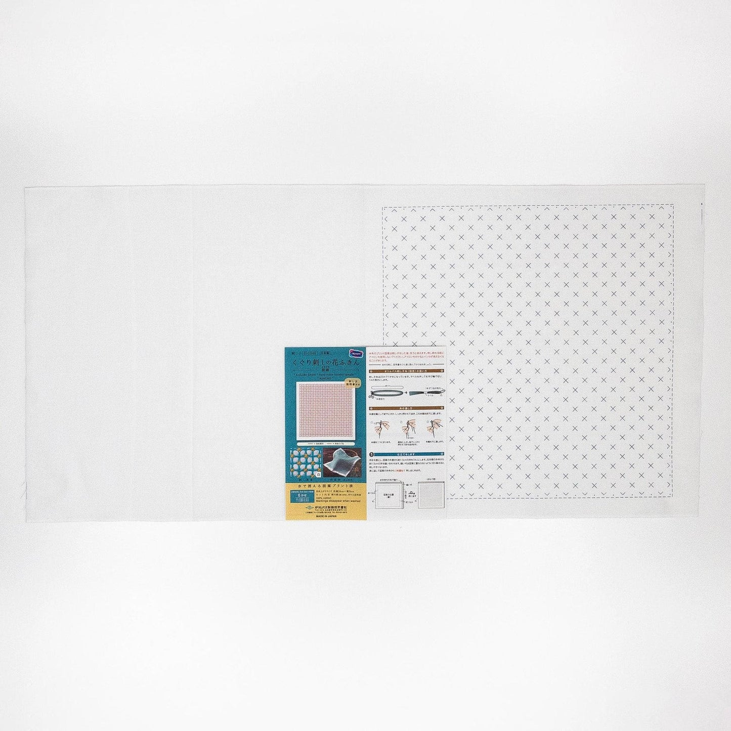 The image is a white background with a square pattern and a small rectangular piece of paper with text and images attached to it.