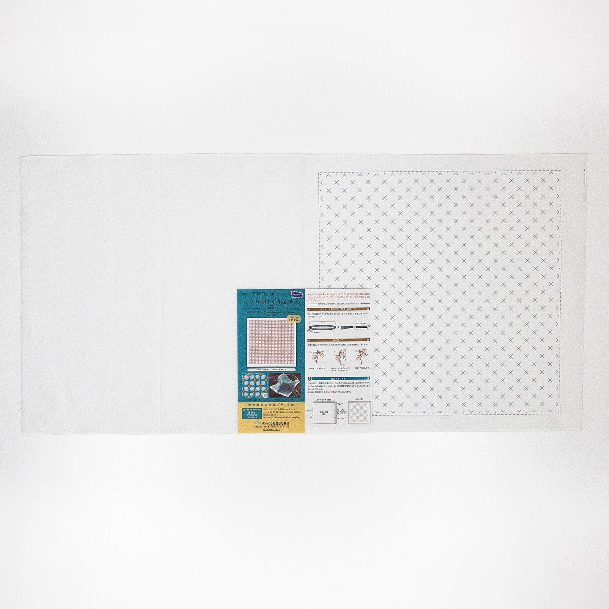 The image is a white background with a square pattern and a small rectangular piece of paper with text and images attached to it.