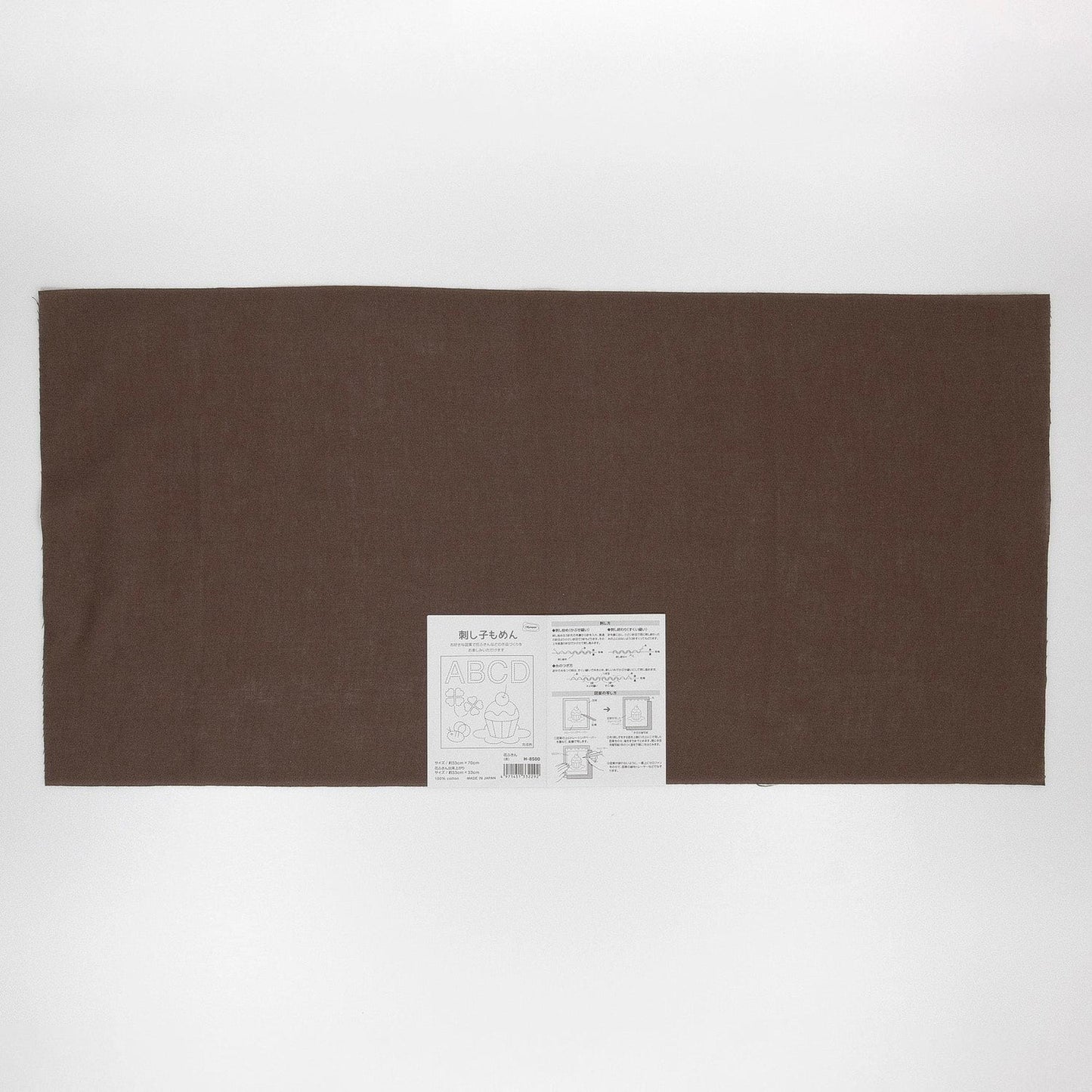 The image is a large rectangular brown fabric with a white label in the bottom right corner.