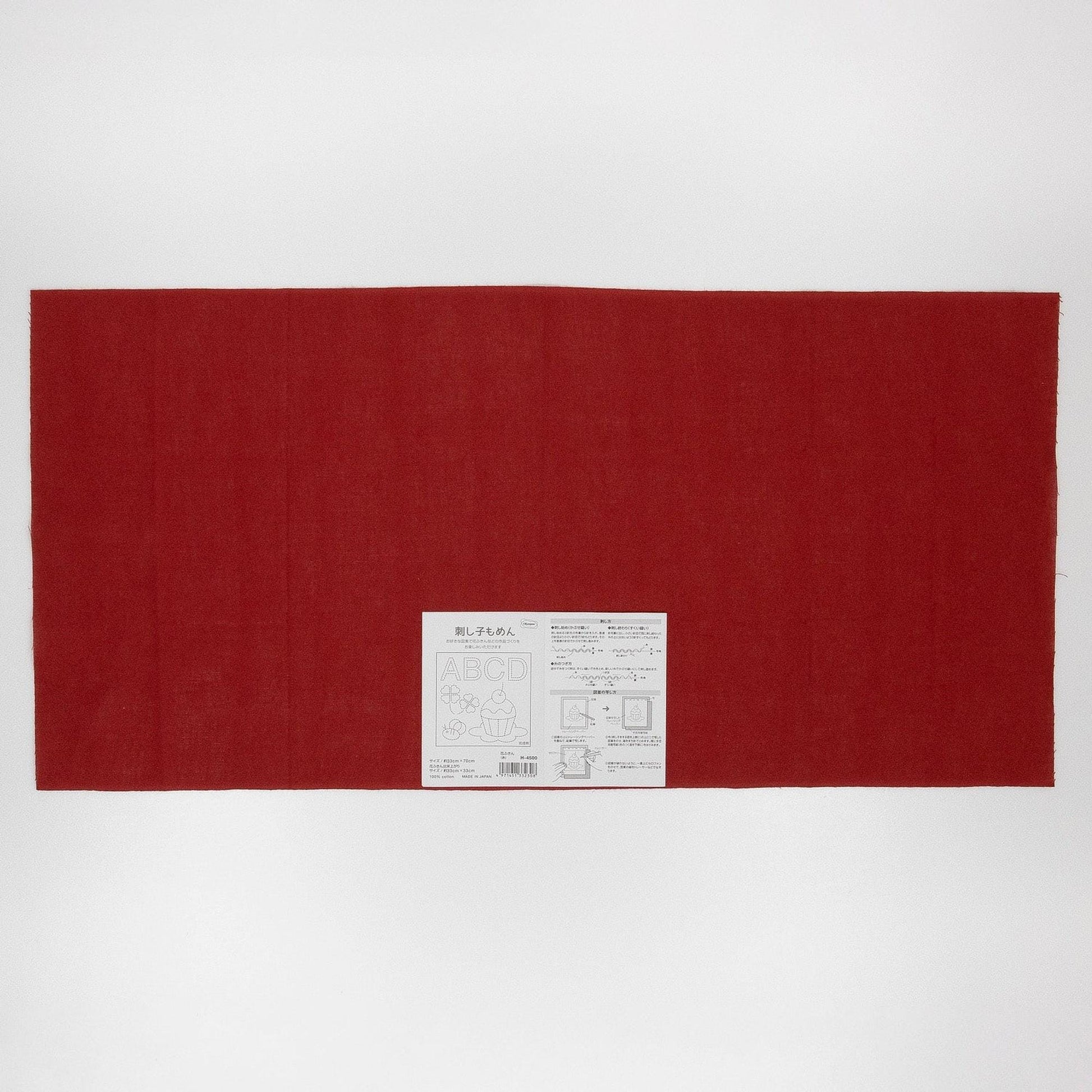 The image is a large red fabric or cloth with a white label or tag attached to it, which appears to be a product or packaging.