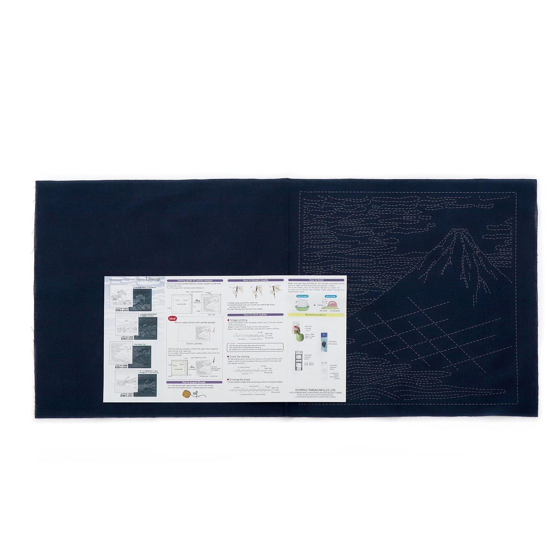 The image is a black and white photograph of a large piece of paper with instructions or information printed on it, placed on a dark surface.