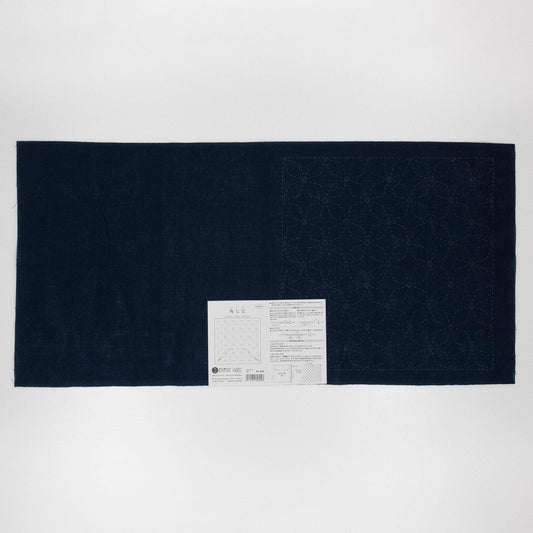 The image is a black fabric with a white label attached to it, which appears to be a piece of paper with text and a diagram.