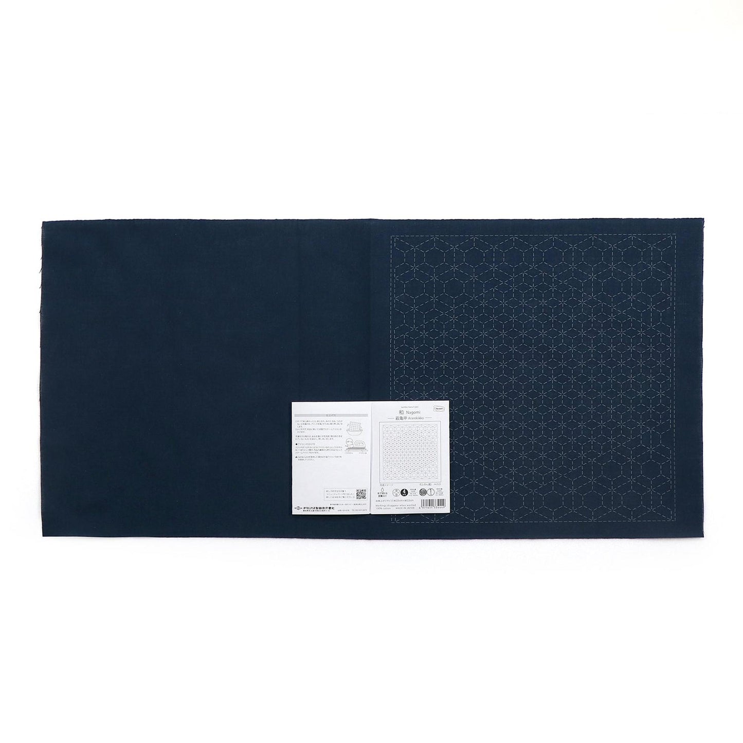 The image is a dark blue fabric with a white label attached to it.
