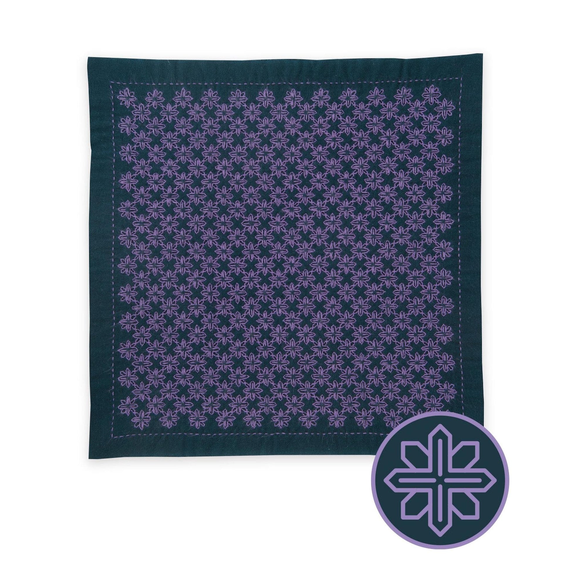 a square-shaped fabric with a repeating pattern of purple flowers or snowflakes on a dark background.