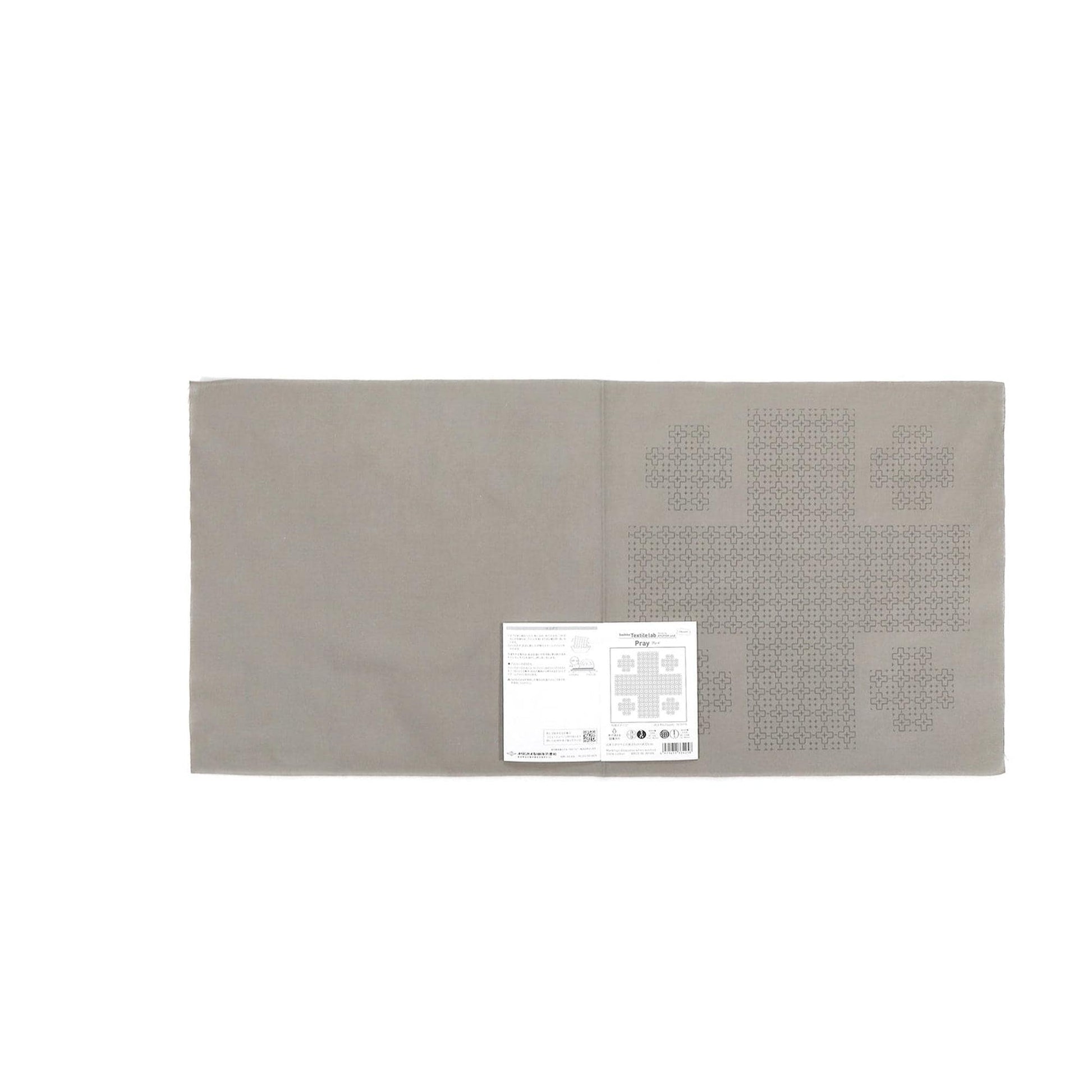 The image is a gray fabric with a white label attached to it, which appears to be a sewing or crafting material.