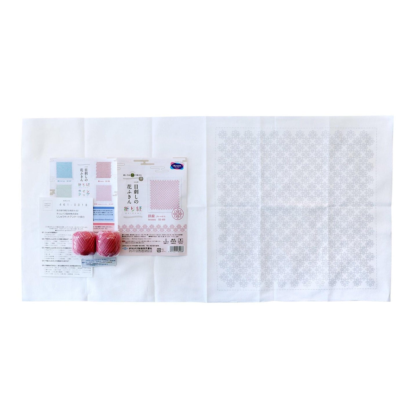 various items, including a white cloth with a pattern, a package of fruit, and some other miscellaneous objects.
