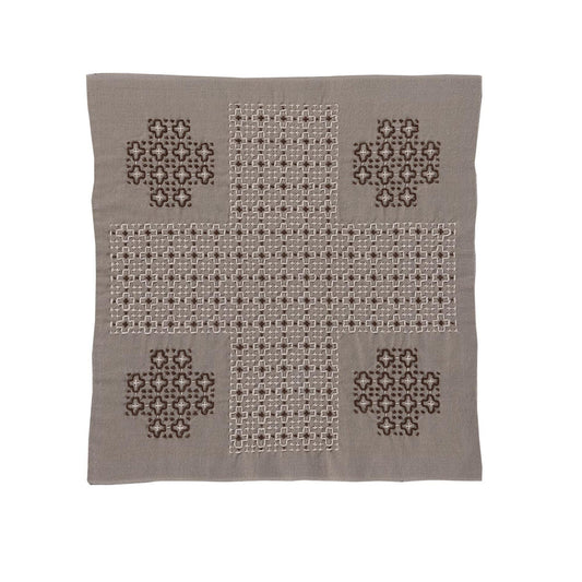 a square-shaped piece of fabric with a cross pattern and four smaller square patterns on each side.