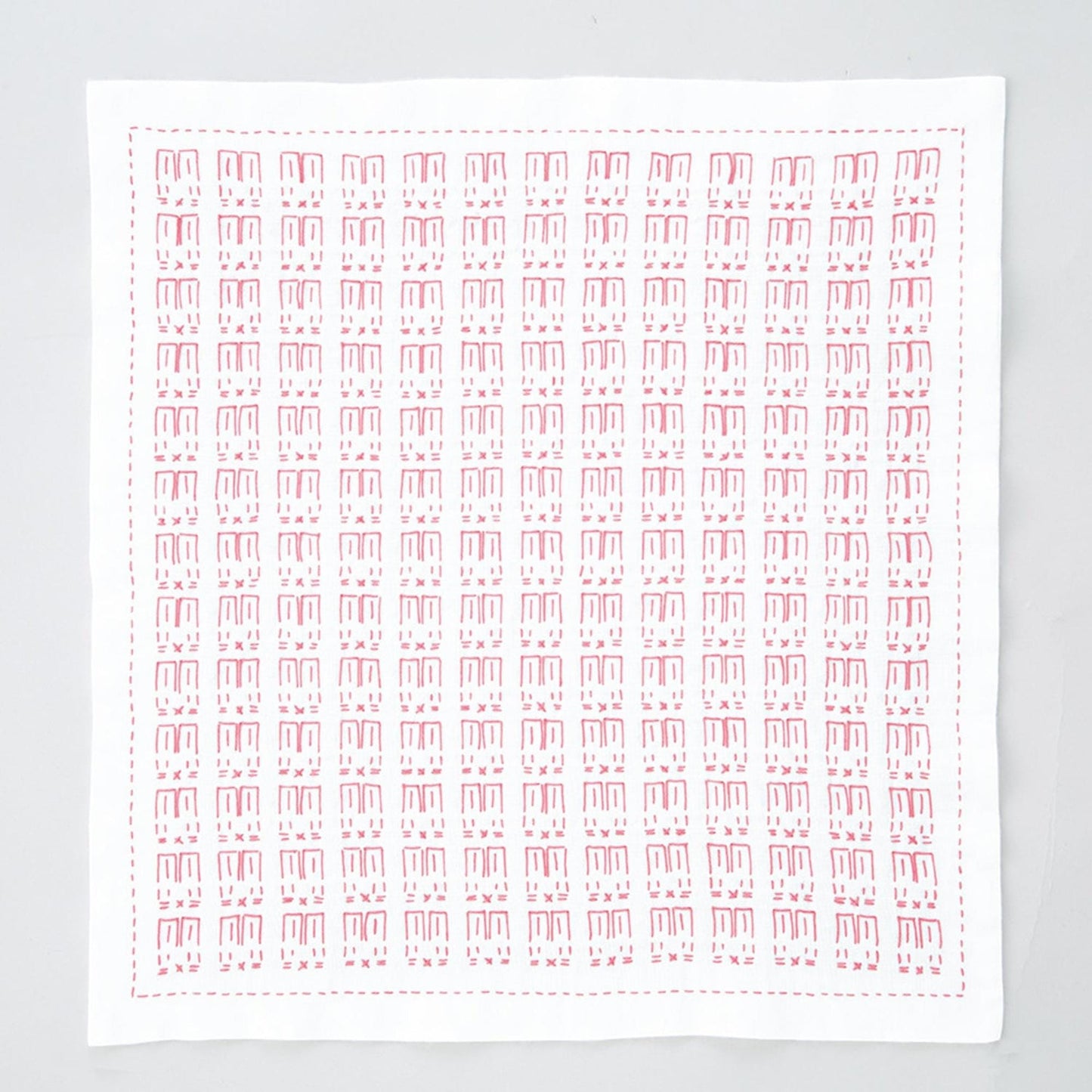 The image is a square with a repeating pattern of red and white shapes, resembling a handkerchief or a piece of fabric.