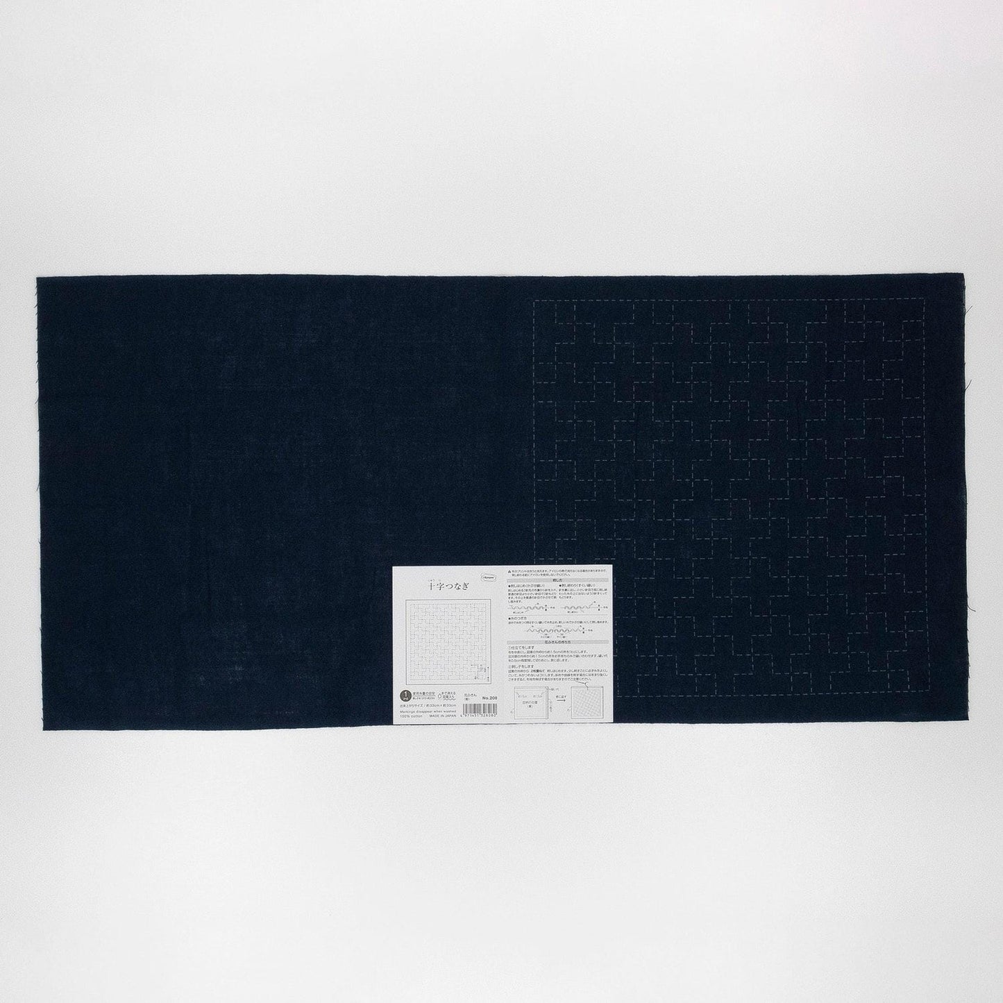The image is a dark blue fabric with a white label attached to it, which appears to be a piece of paper or a printed document.