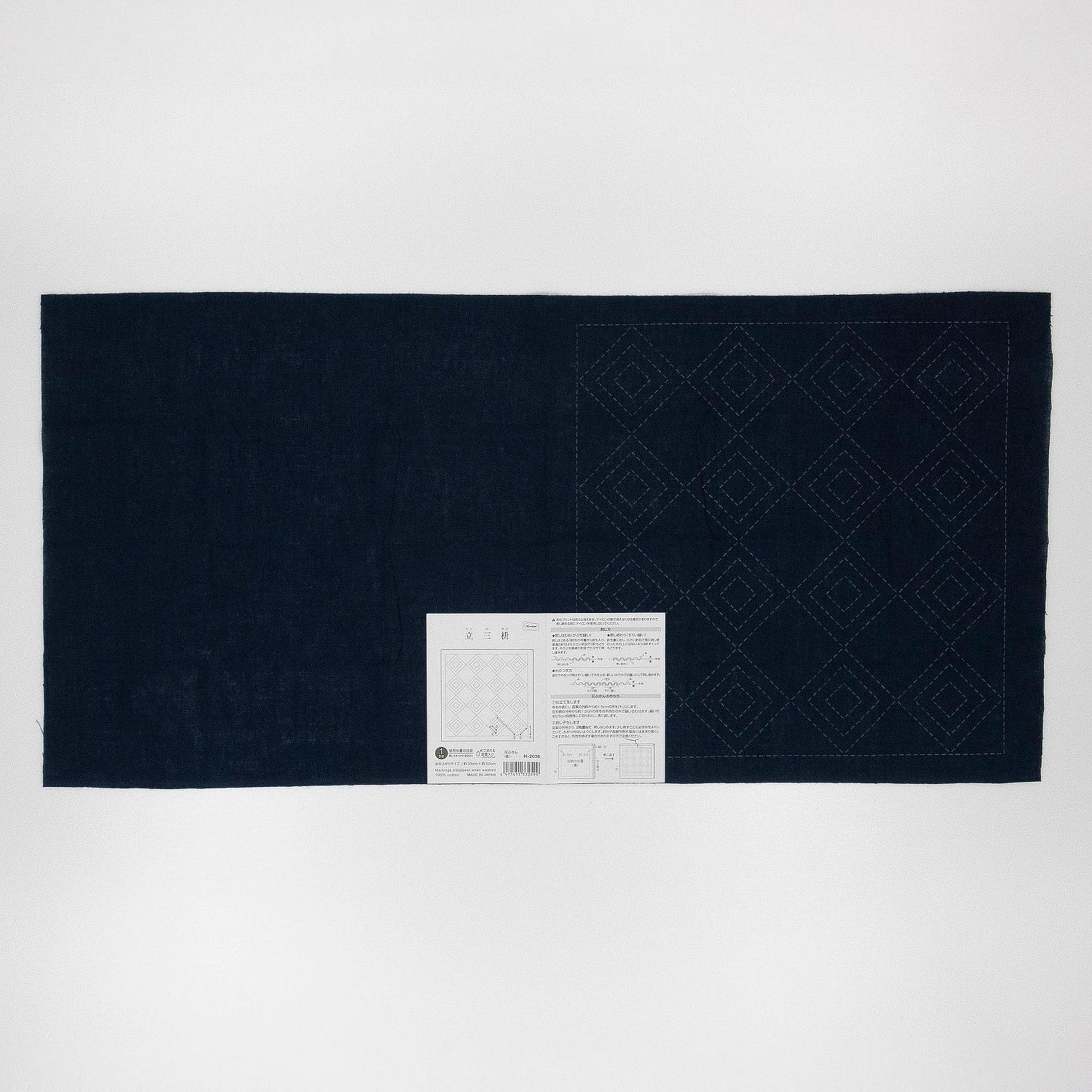 The image is a dark blue fabric with a white diamond pattern on it.