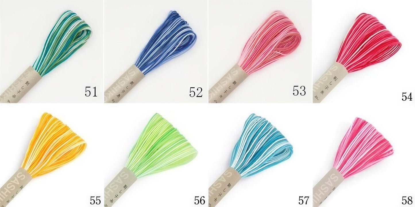 a collection of eight different colored spools of thread, each with a unique color and pattern.