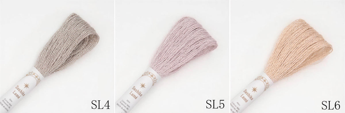 three different spools of thread, each with a different color: gray, pink, and peach.