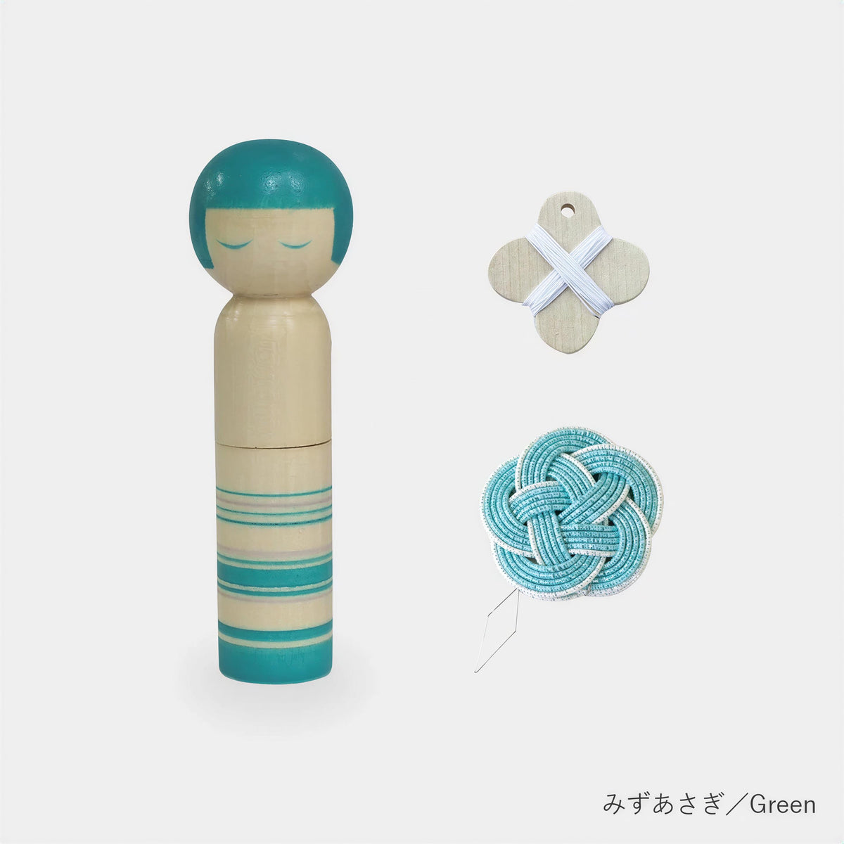 a wooden doll with a turquoise head, a wooden cross, and a blue and white knotted string.