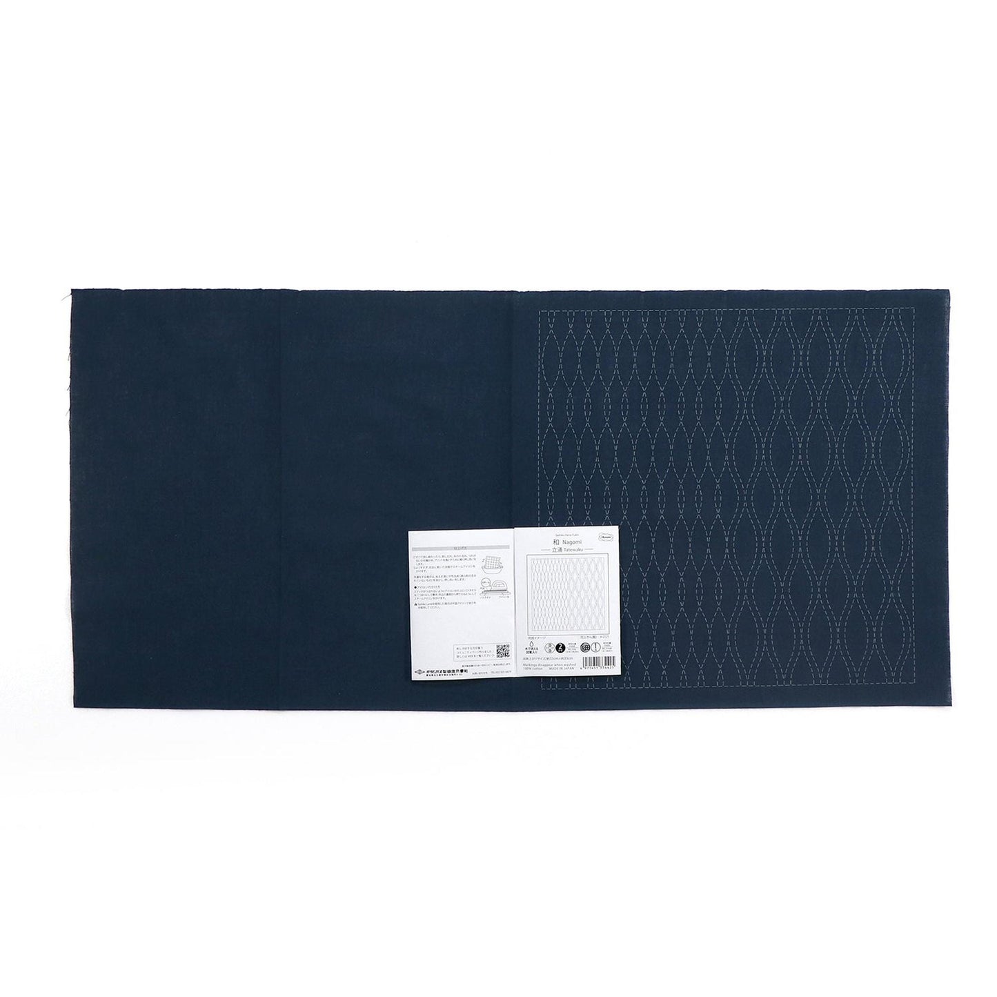 The image is a dark blue fabric with a white label attached to it, which appears to be a piece of paper or a printed document.