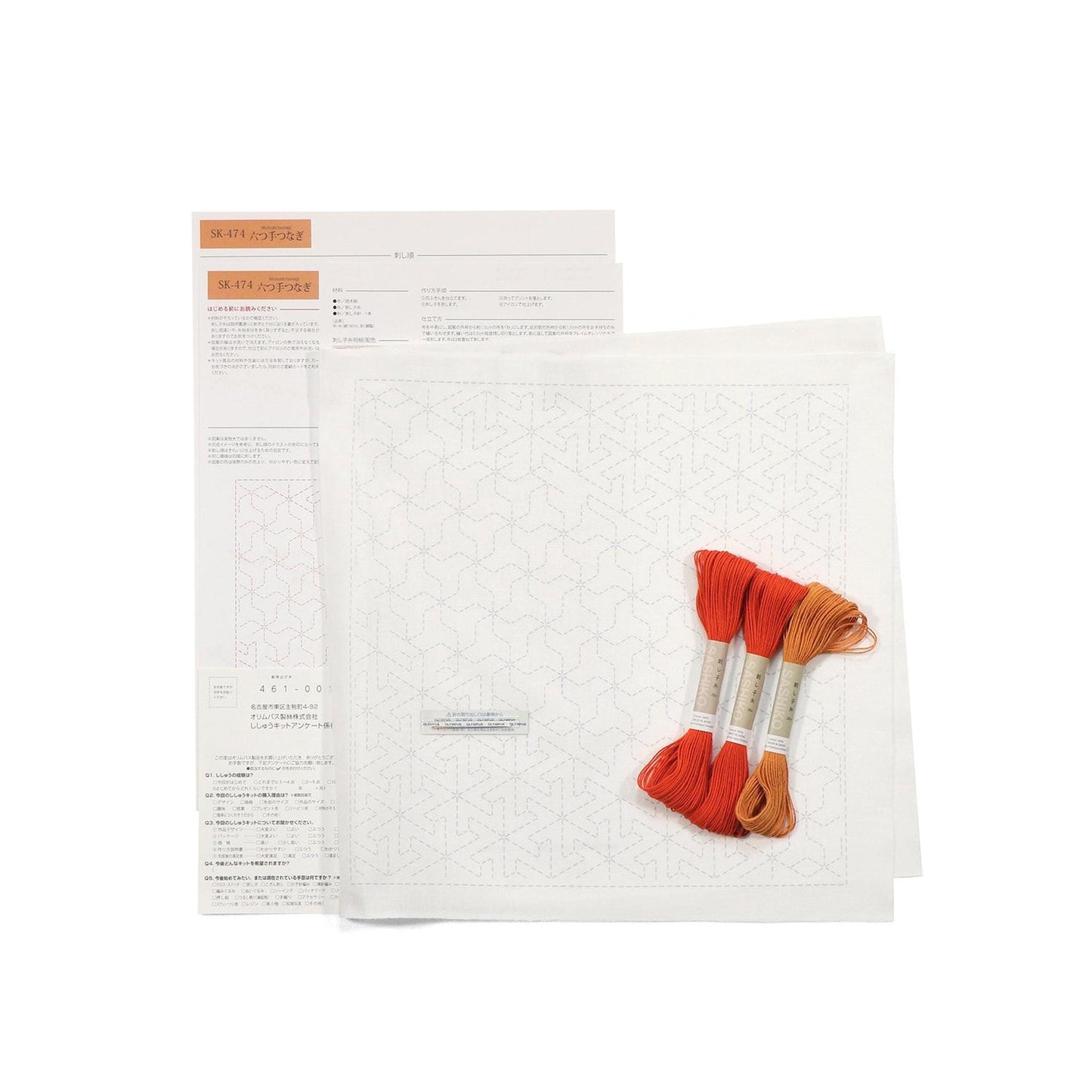 a set of instructions and materials for a sewing or embroidery project, including a pattern, thread, and a ruler.