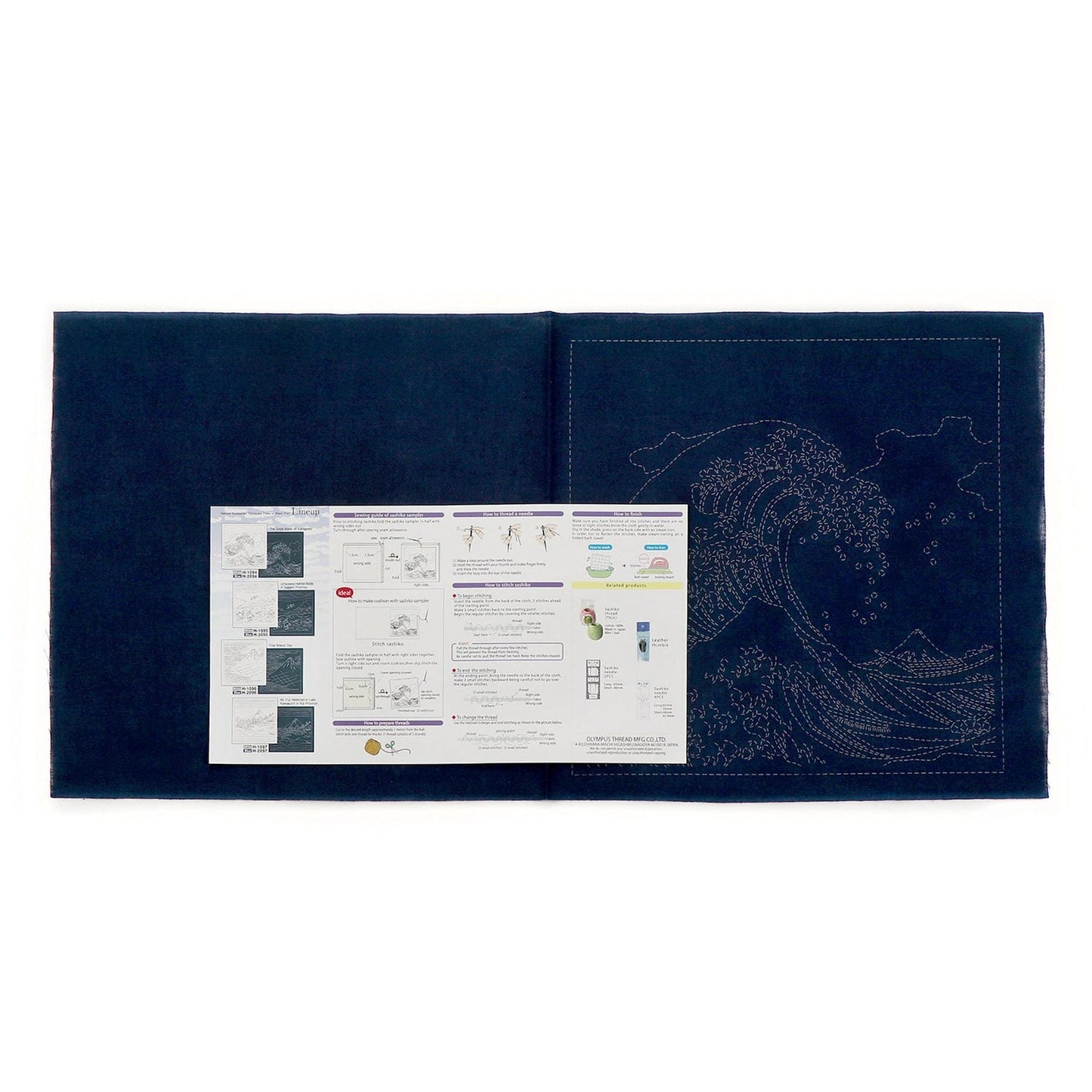 The image is a large blue fabric with a detailed embroidery of a wave pattern on it. The fabric appears to be a sewing or crafting material, possibly used for creating a design or pattern.