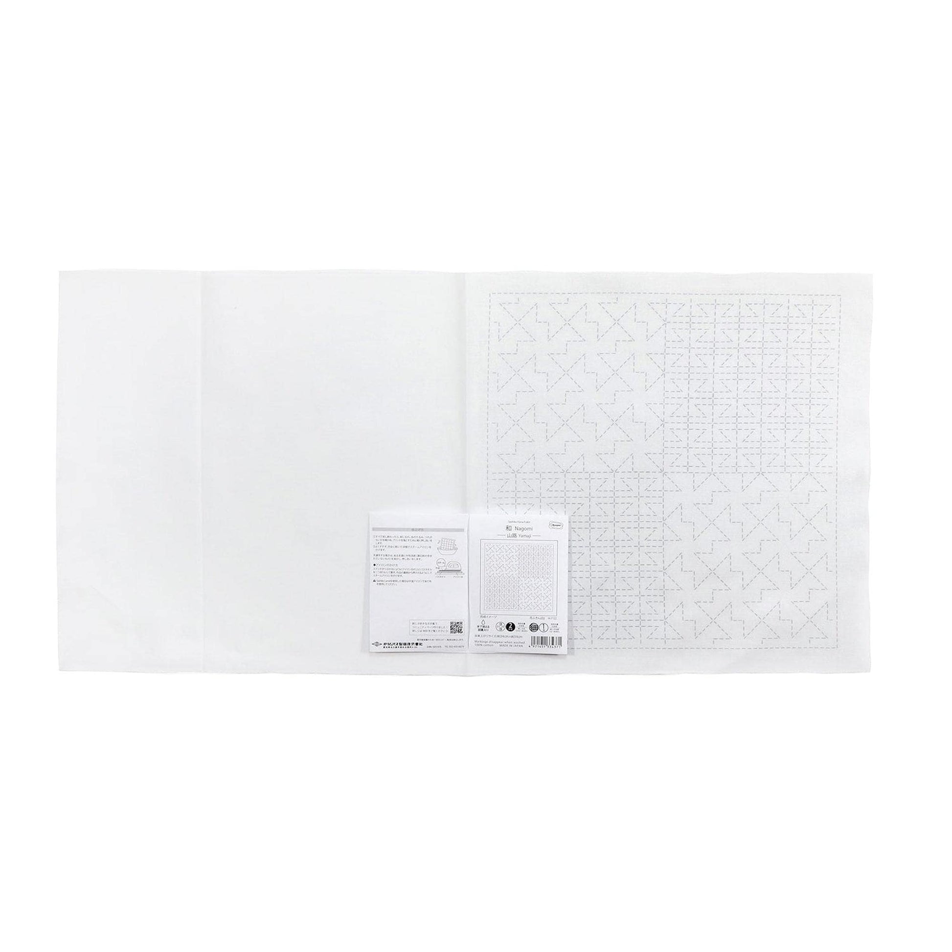 The image is a white sheet of paper with a grid pattern on it, and there is a small piece of paper with text next to it.