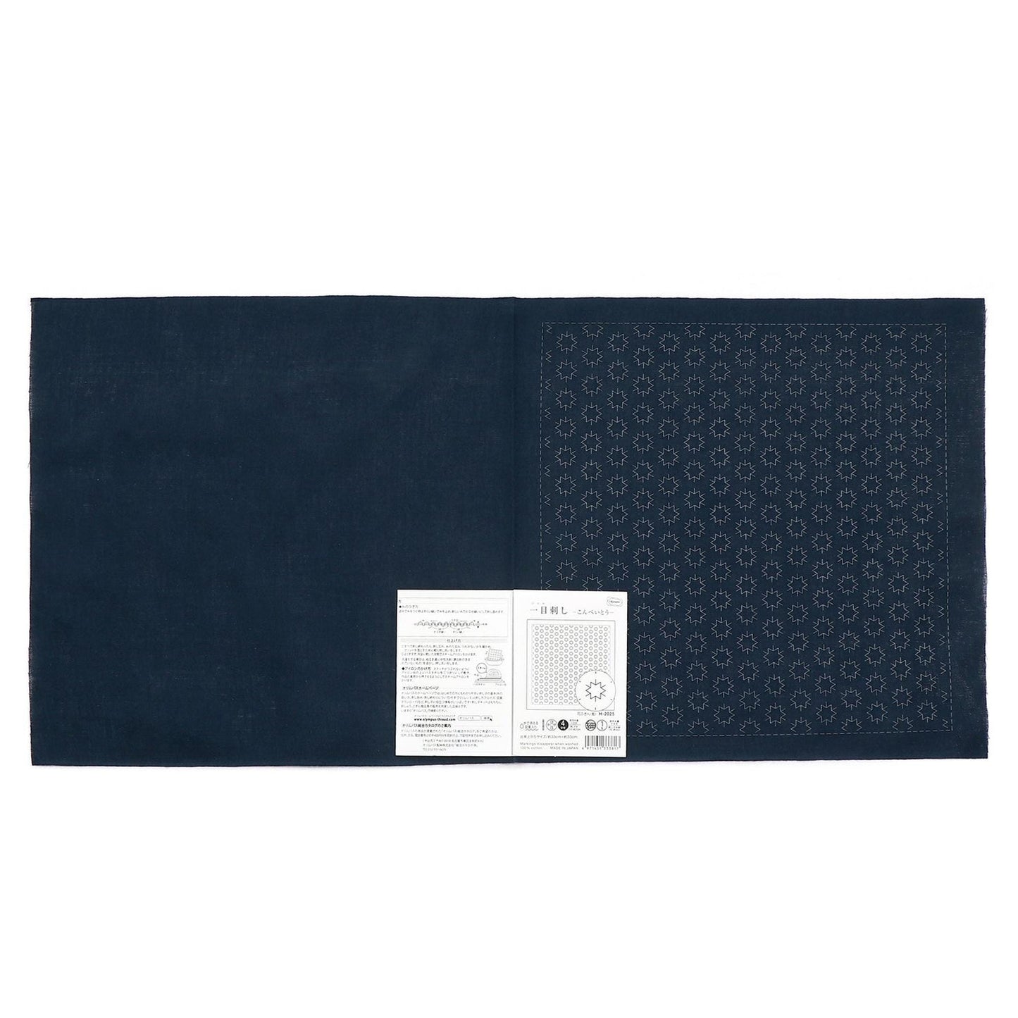 The image is a dark blue fabric with a white label placed on it.