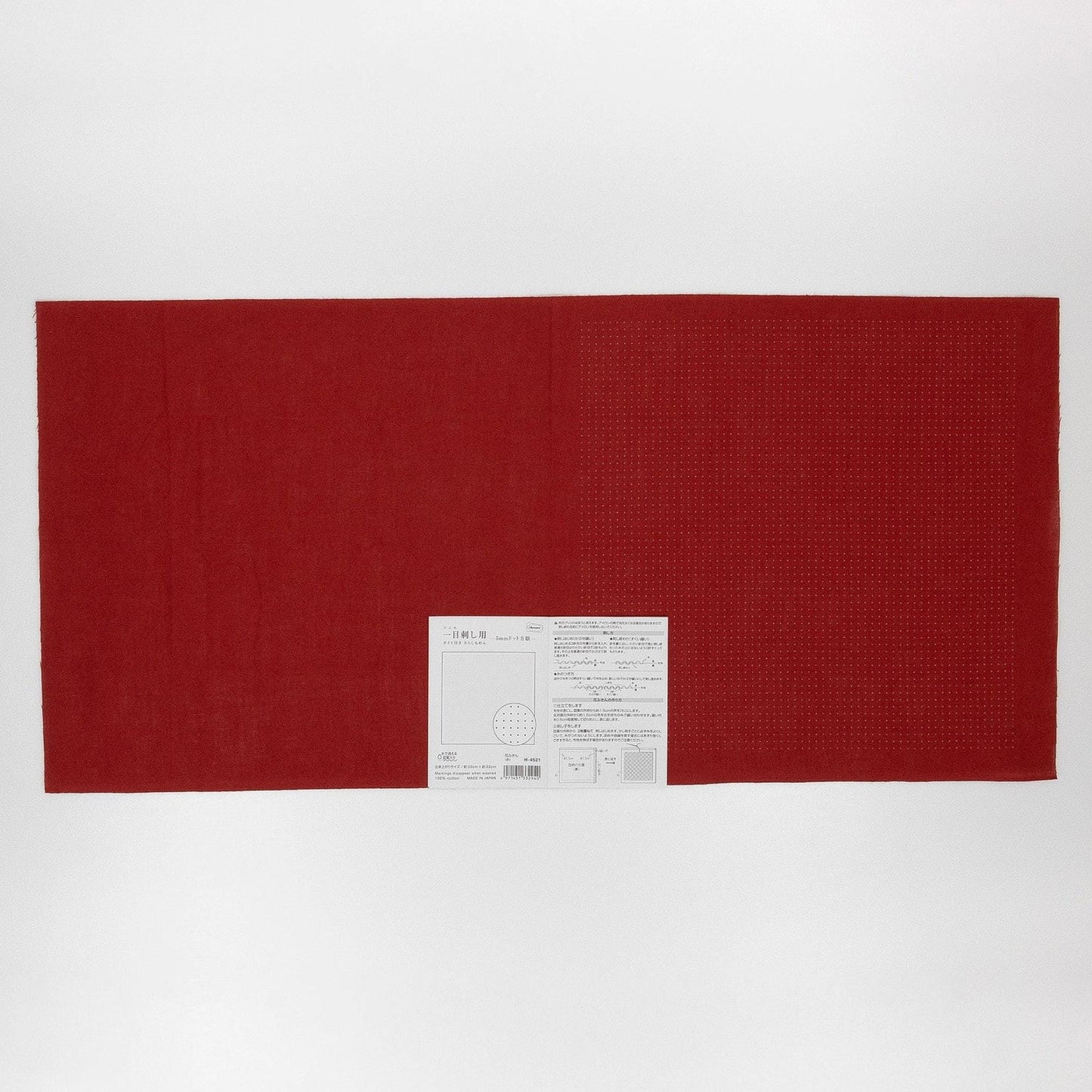 The image is a red fabric with a white label attached to it, placed against a white background.