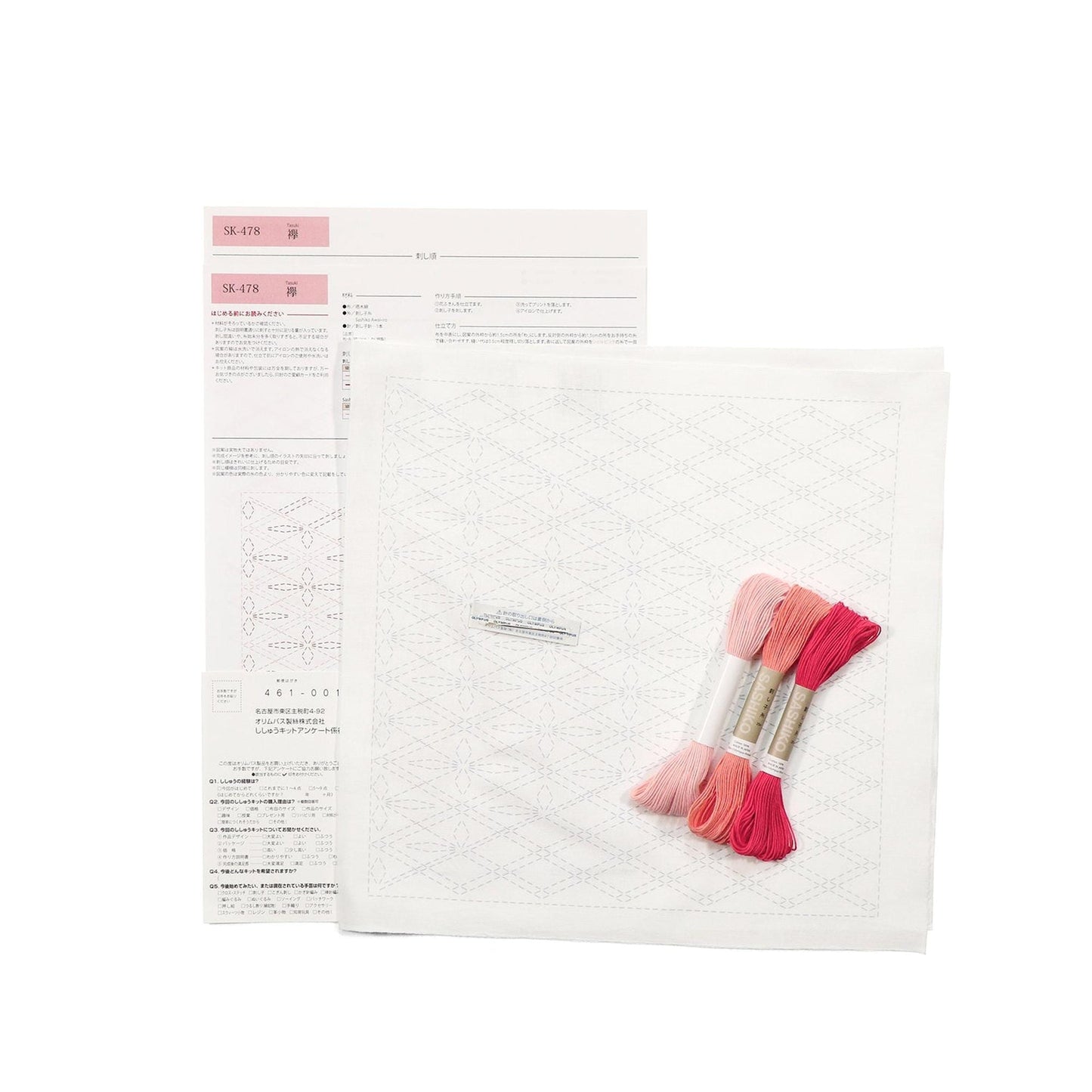 a sewing kit with instructions and materials, including a piece of paper with instructions and a spool of thread.