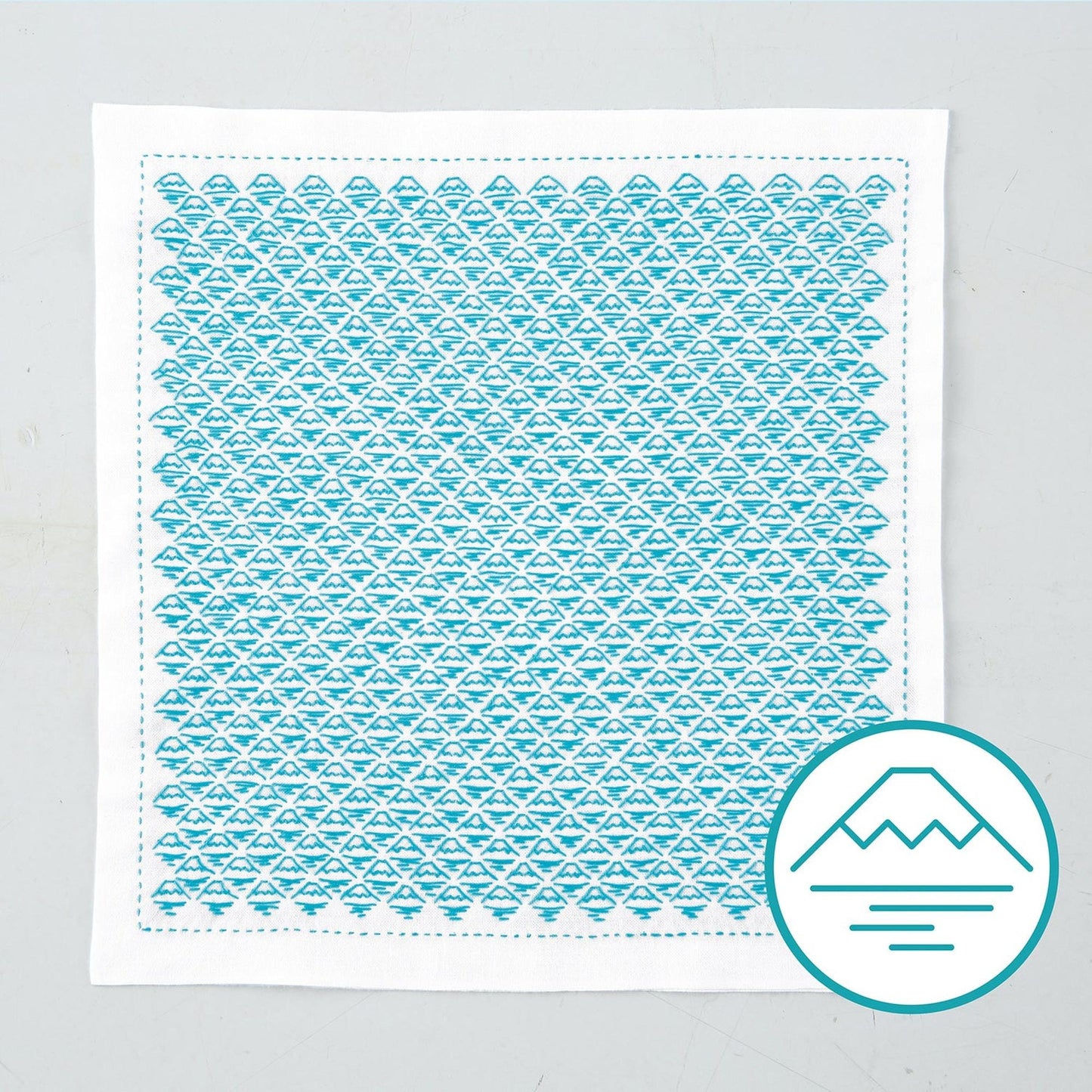 a square piece of fabric with a repeating pattern of blue triangles, creating a visually striking and intricate design.