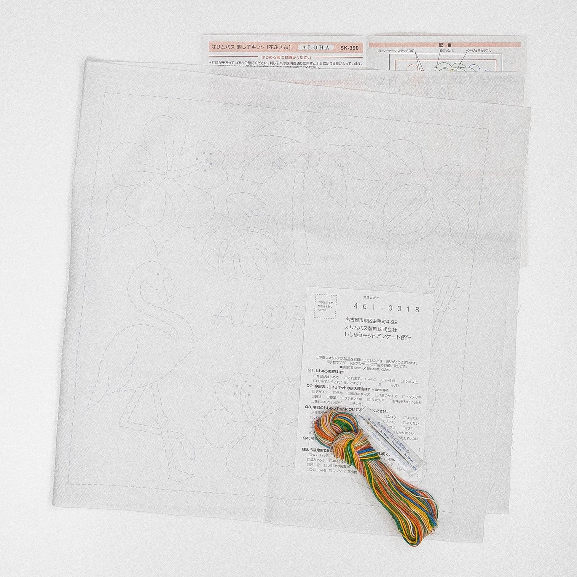 a piece of paper with a drawing of a flower and a piece of thread, along with some other items, such as a piece of paper with text and a label.