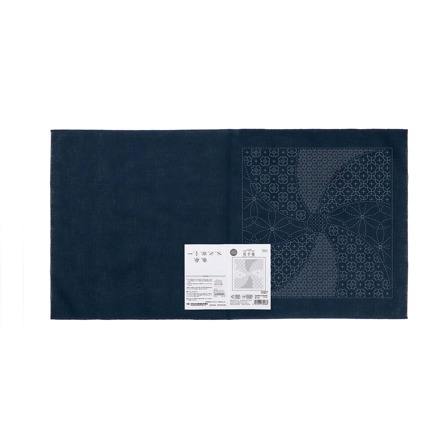 The image is a dark blue fabric with a white label attached to it, which appears to be a sewing or crafting material.