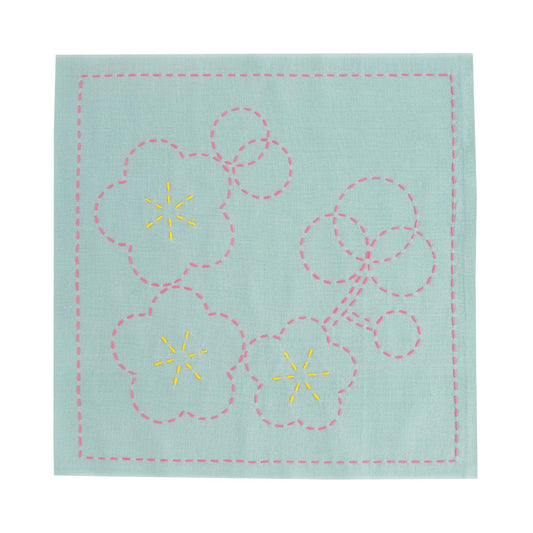 a square piece of fabric with a floral design, including three pink flowers with yellow centers and a pink stem.