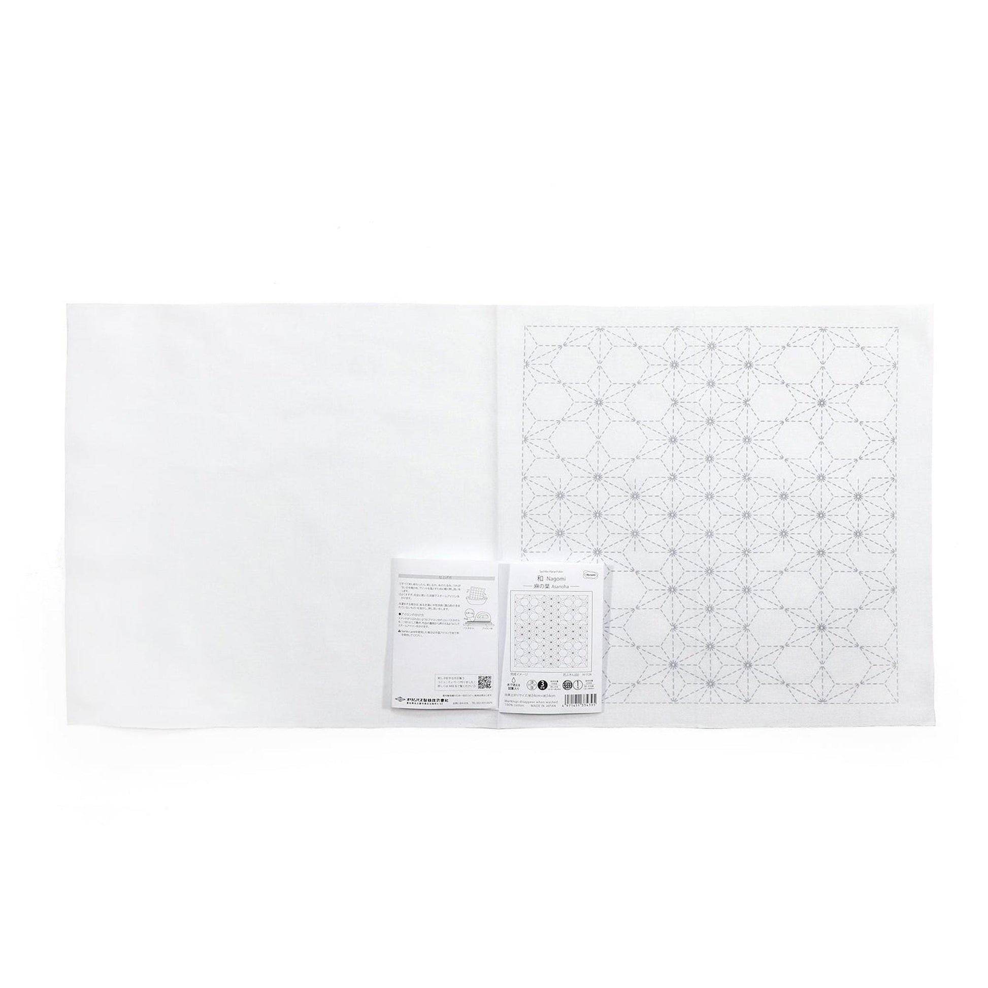The image is a white sheet of paper with a black geometric pattern printed on it. There is also a small white label or piece of paper with text next to the printed pattern.