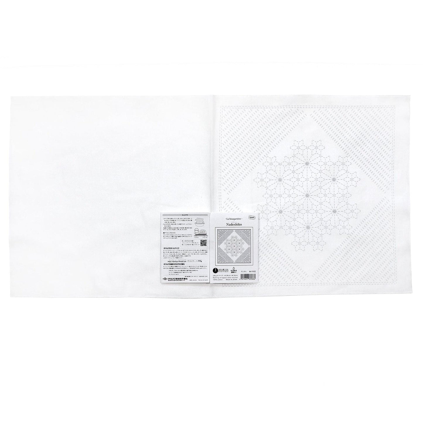 The image is a white square with a black and white pattern on it, and there is a small label or package attached to the right side of the square.