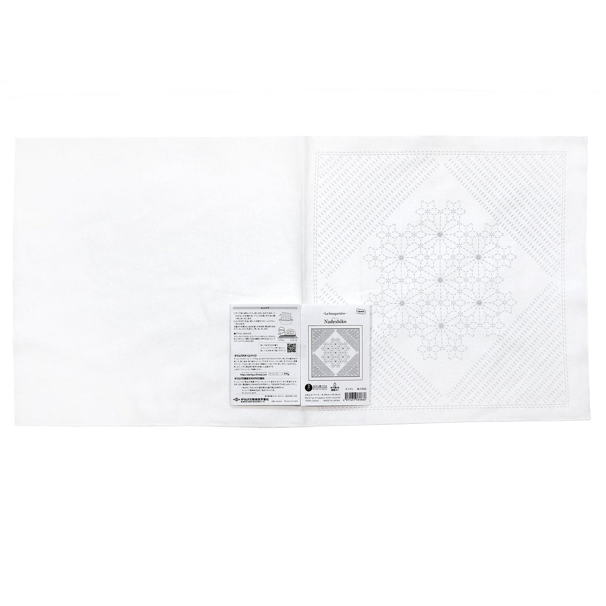 The image is a white square with a black and white pattern on it, and there is a small label or package attached to the right side of the square.