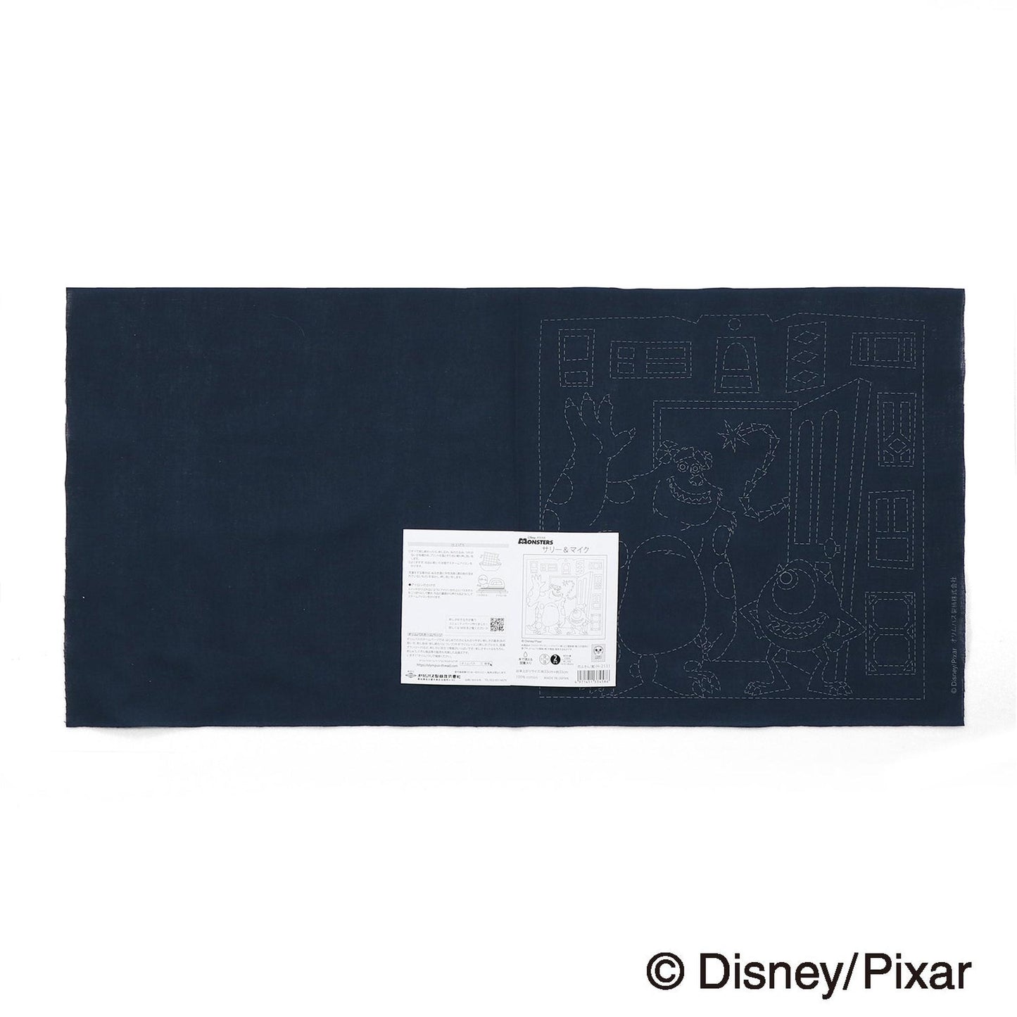 A dark blue fabric with a white label featuring a drawing of a character from the Disney Pixar film "Disney/Pixar".