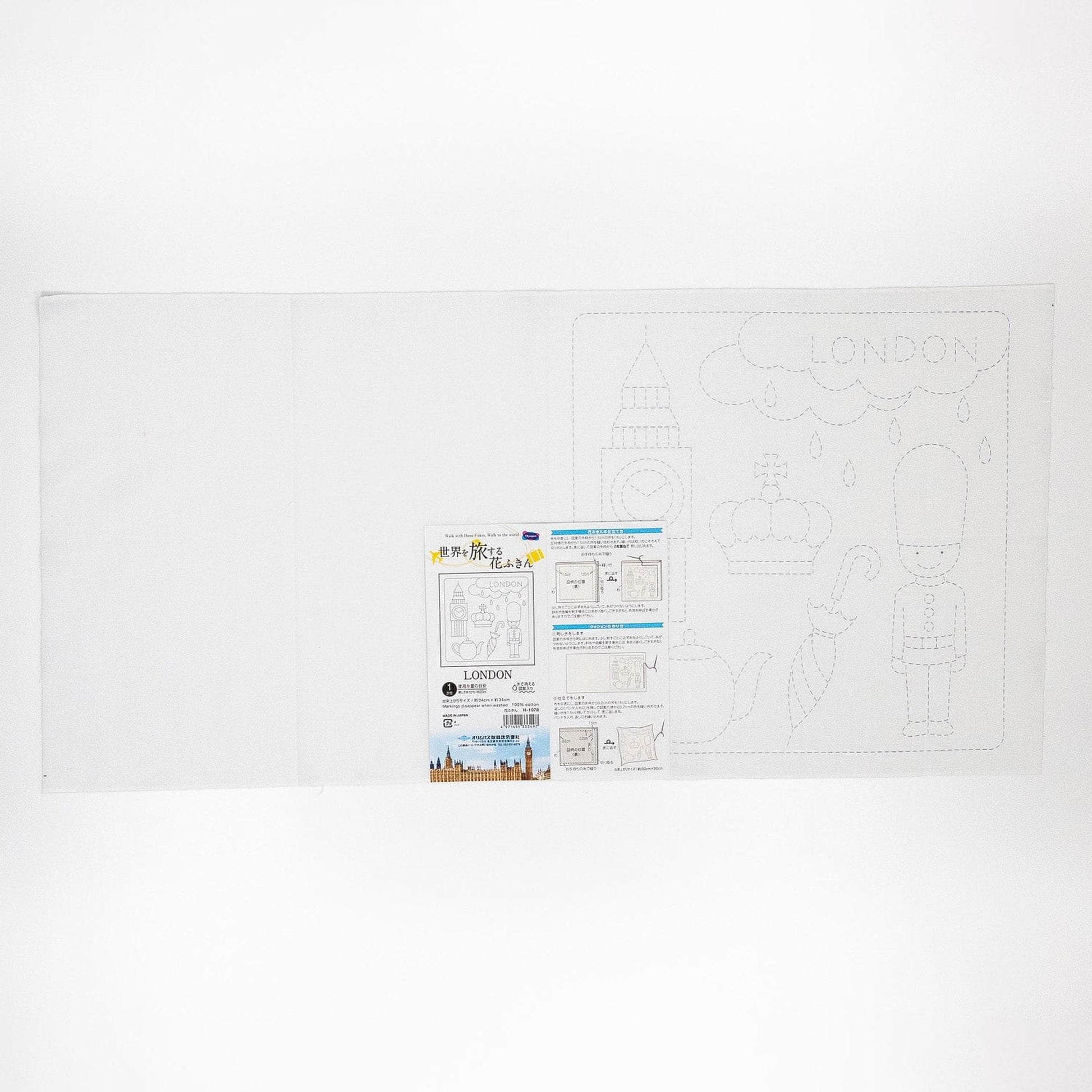 The image is a white sheet of paper with a drawing of a city and the word "LONDON" written on it. There is also a small label or instruction sheet attached to the paper, which appears to be a guide or instructions related to the drawing.