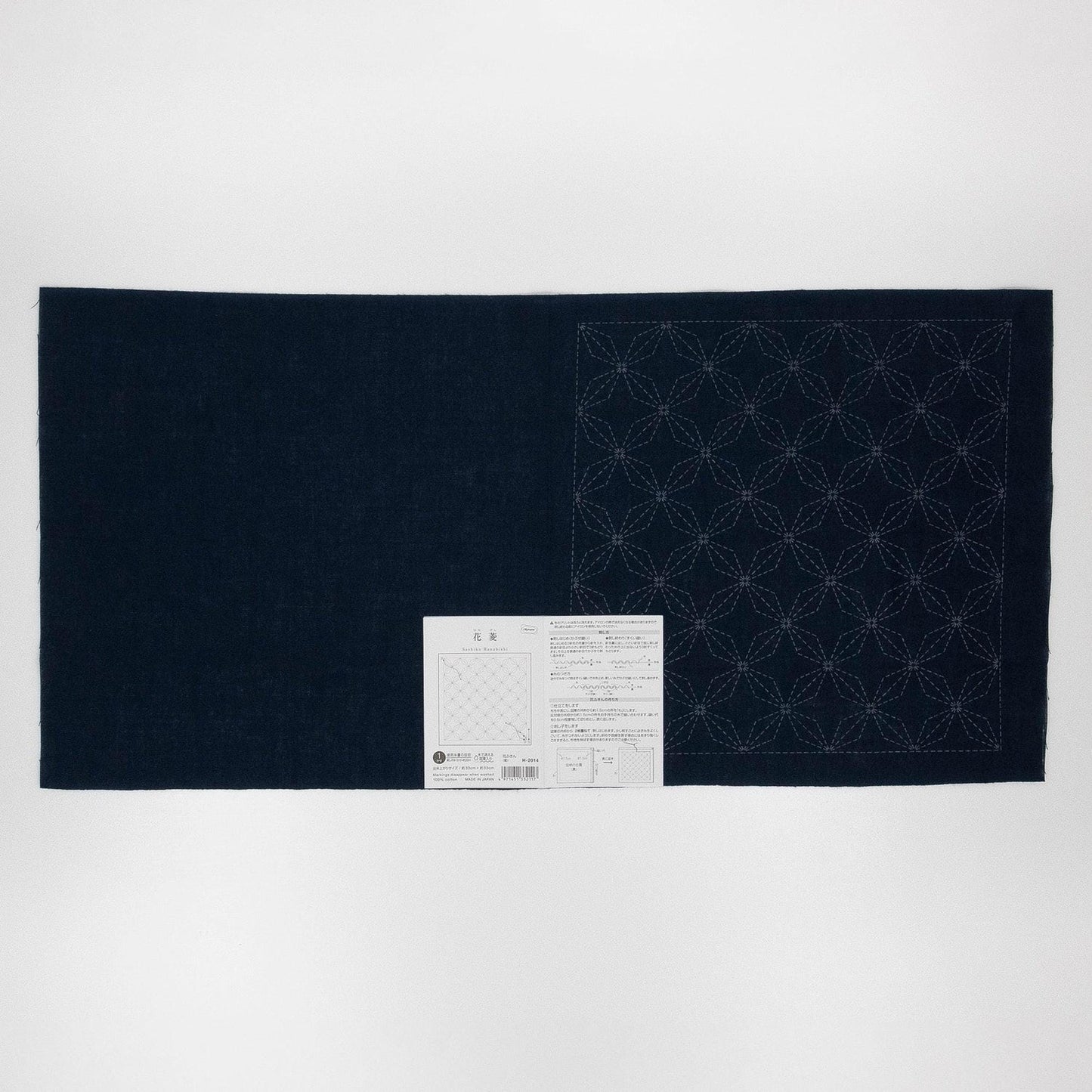 a dark blue fabric with a white pattern on it, placed on a white background.