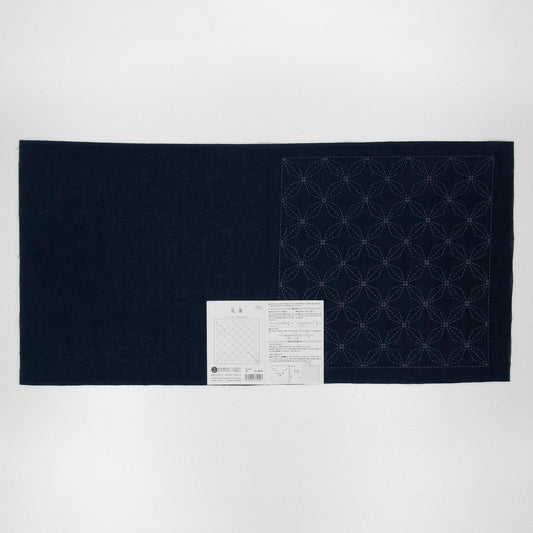 a dark blue fabric with a white pattern on it, placed on a white background.