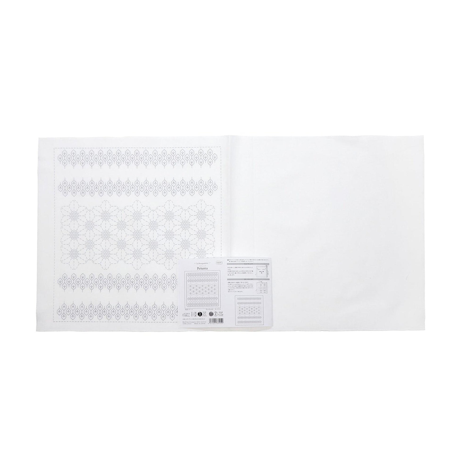 The image is a white paper with a pattern of snowflakes on it.