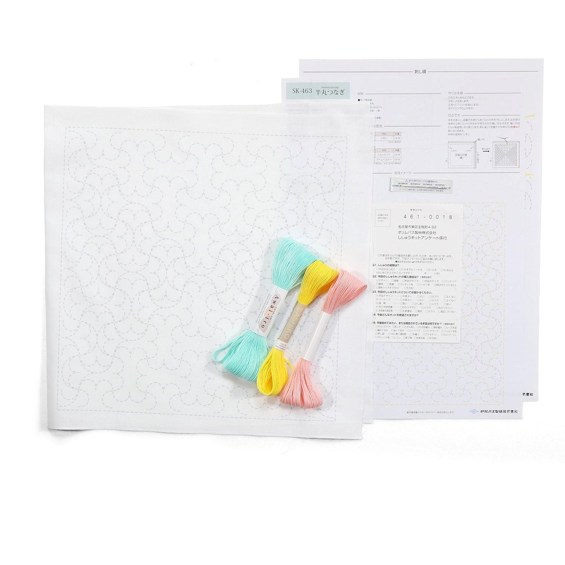 a sewing kit with a white paper pattern, colorful thread, and instructions for a sewing project.