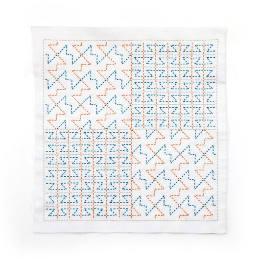 The image is a square with a repeating pattern of blue and orange triangles and squares, creating a visually striking and intricate design.