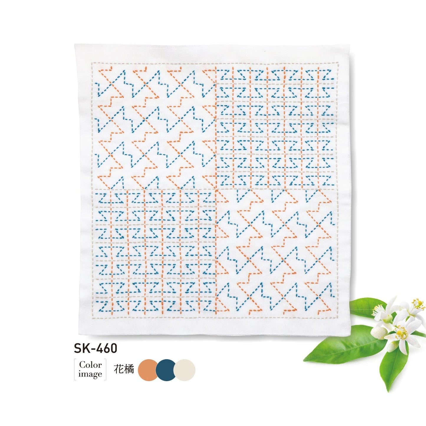 The image is a square piece of fabric with a repeating pattern of orange and blue geometric shapes, accompanied by a small white flower and green leaves.