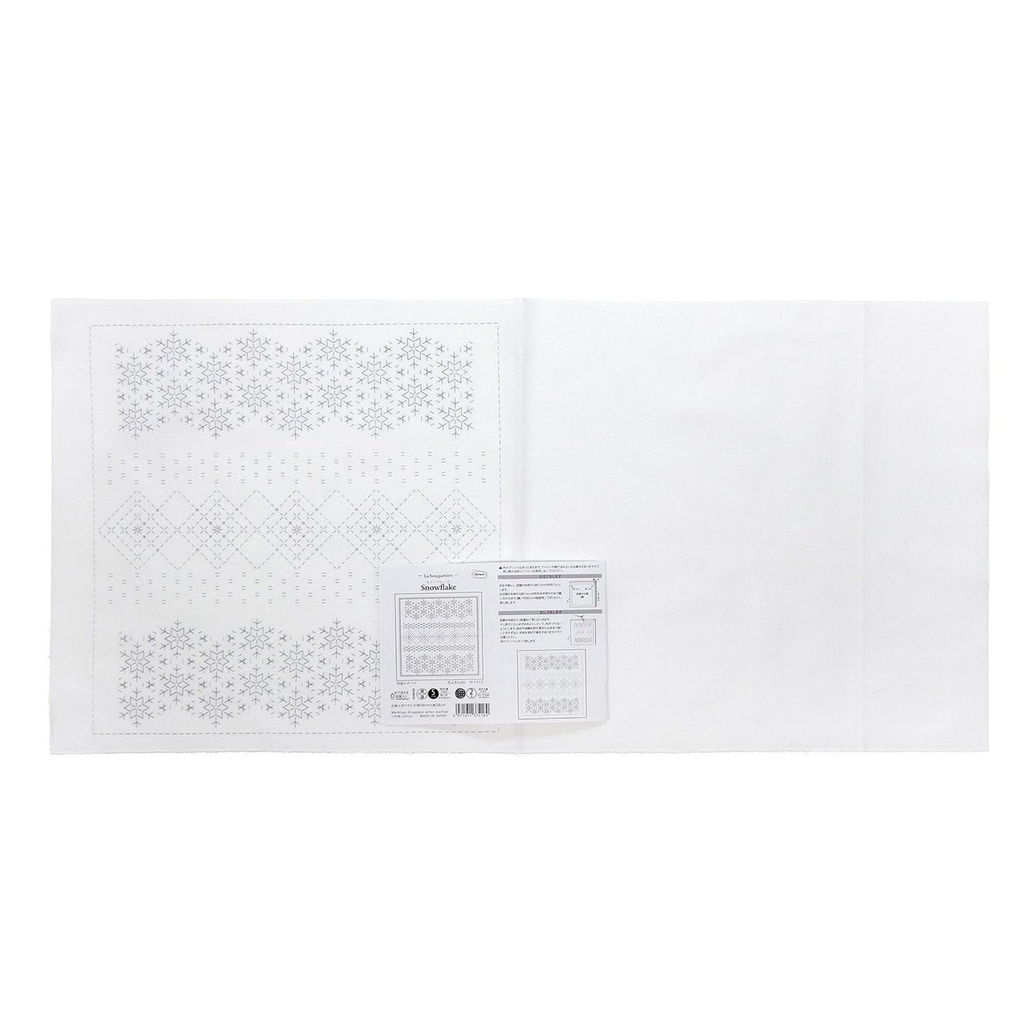 The image is a white sheet of paper with a pattern of snowflakes on it.